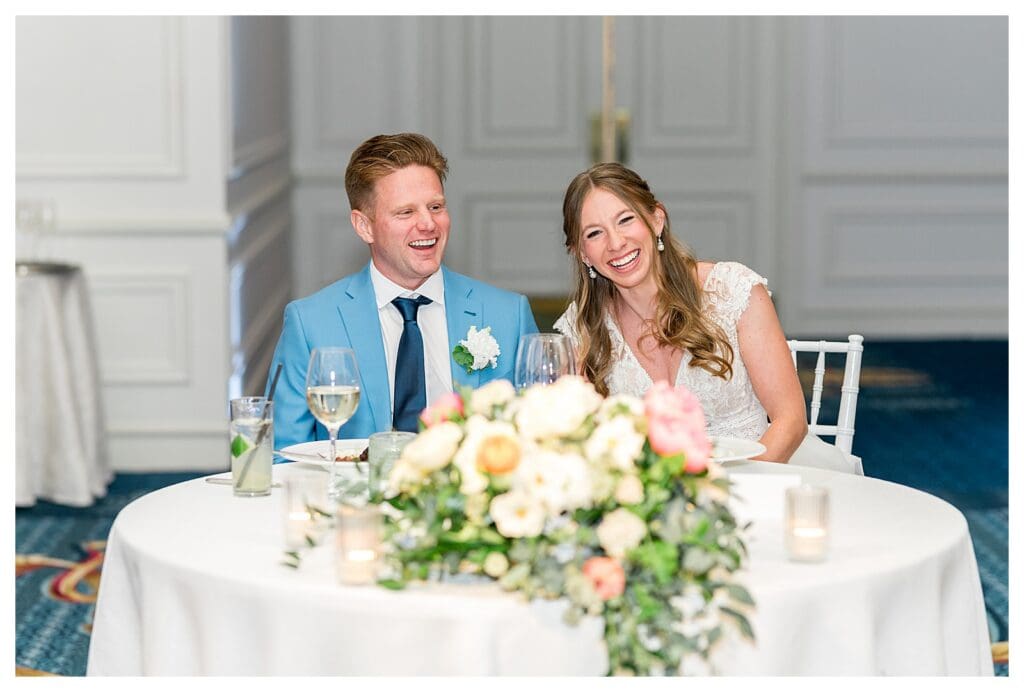 Bride and groom at sweetheart table during reception at Boston Harbor Hotel
