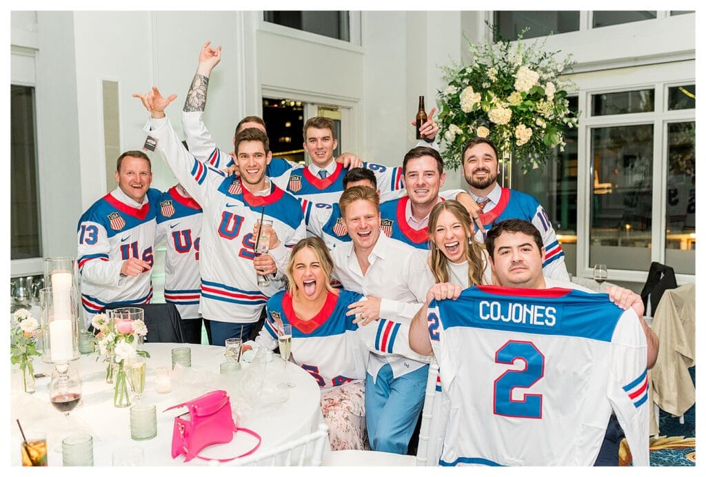 Groom celebrating with guests in fun reception moment at Boston Harbor Hotel