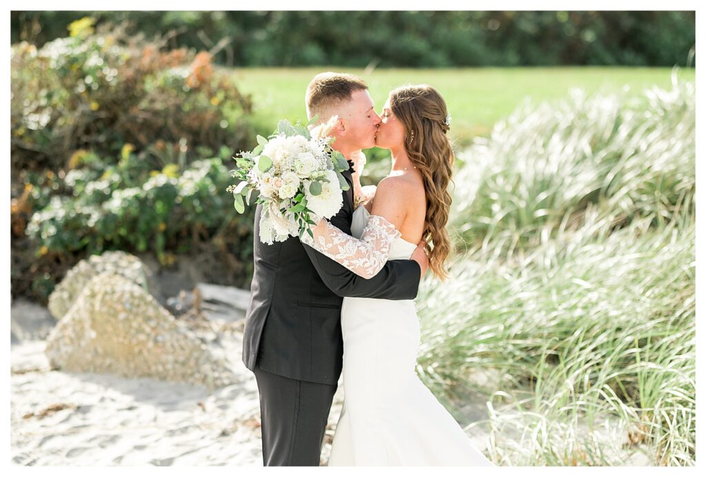 Bride and Groom kissing during their first look at Newport Beach House.