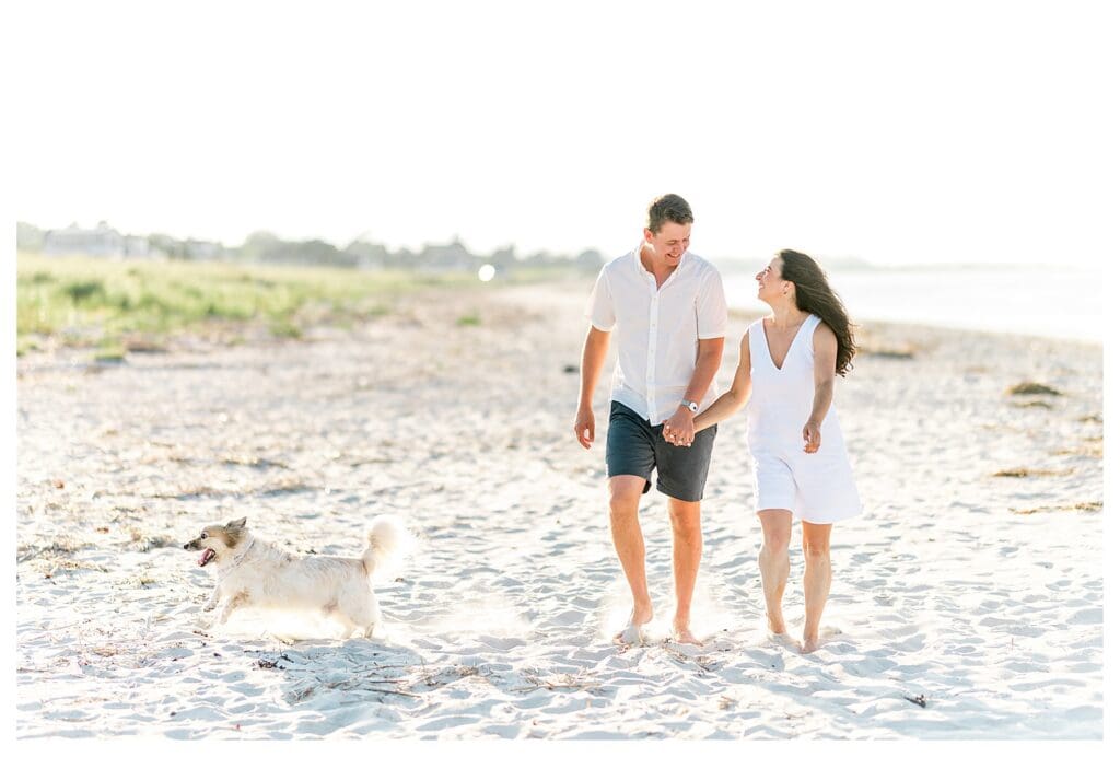 Running together along the beach during Massachusetts beach engagement photos