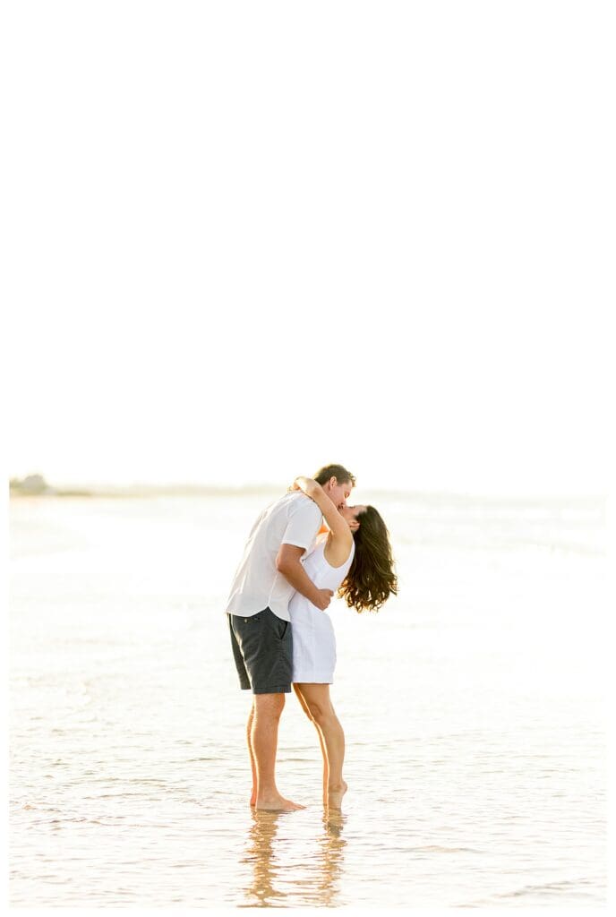 Embracing and kissing on Wingaersheek Beach at sunset