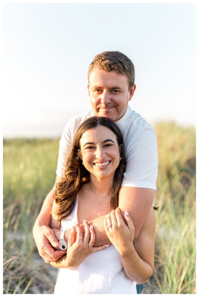 Embracing and smiling during Gloucester engagement photos