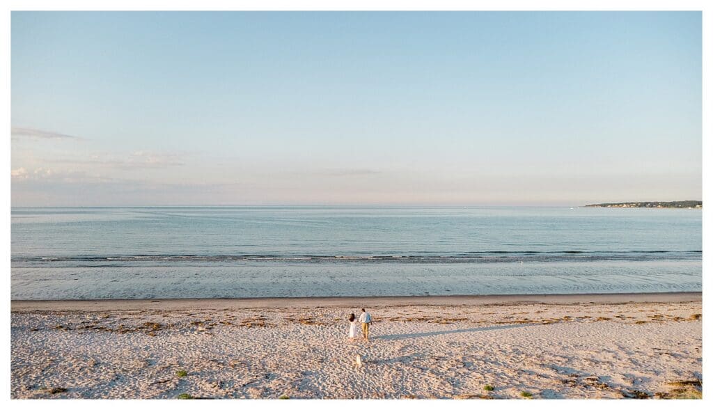 Aerial view of two people walking along the shoreline at Wingaersheek Beach