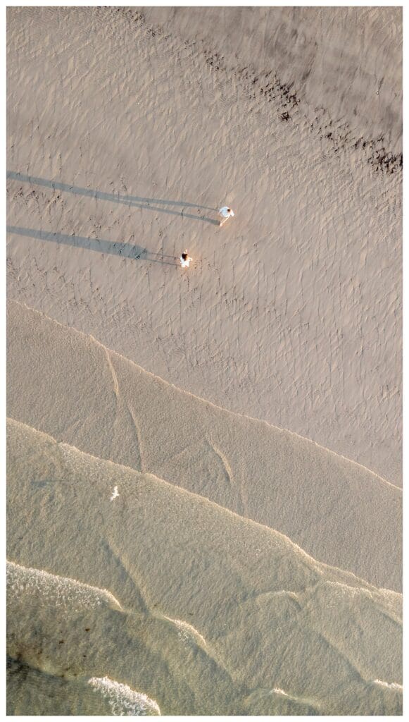 Aerial view of the ocean and shoreline at sunset