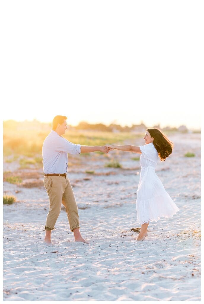 Dancing together during beach engagement photos