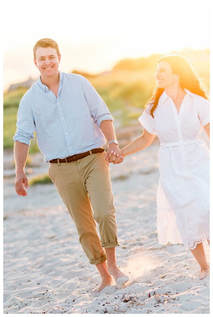 Walking barefoot together along the beach during sunset