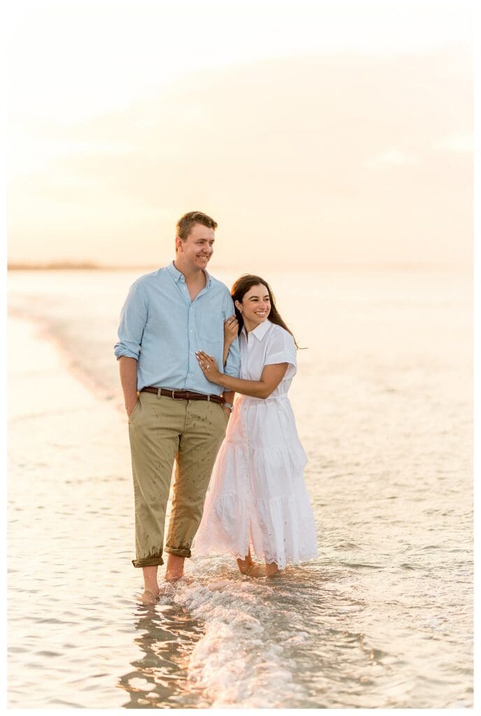 Walking together along the beach with the ocean in the background