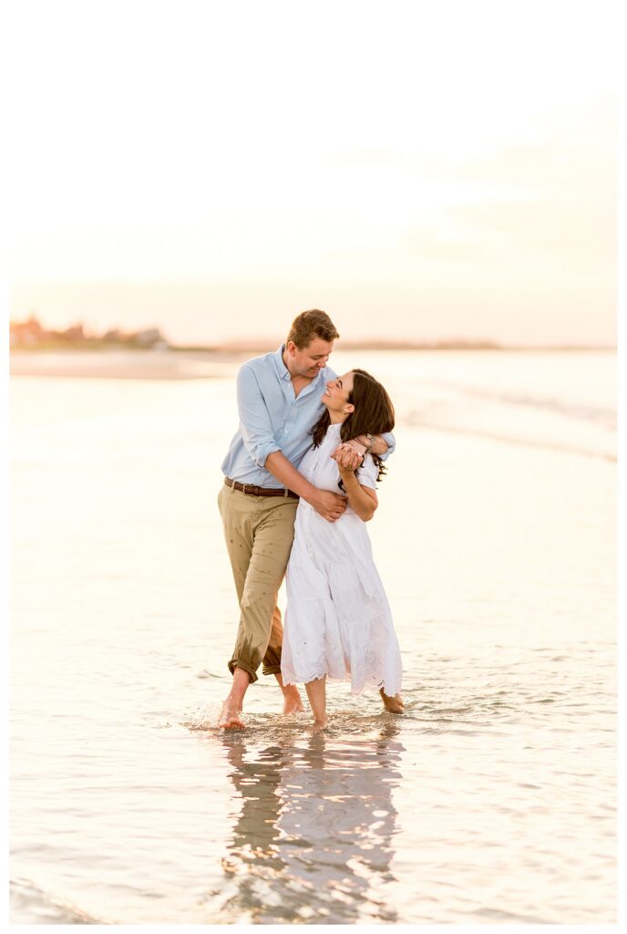 Kissing and laughing together on the beach