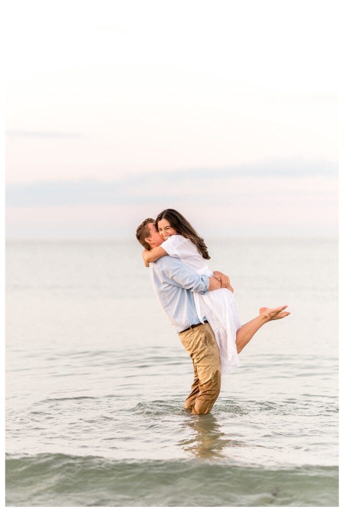Romantic lift on the beach with the ocean behind them