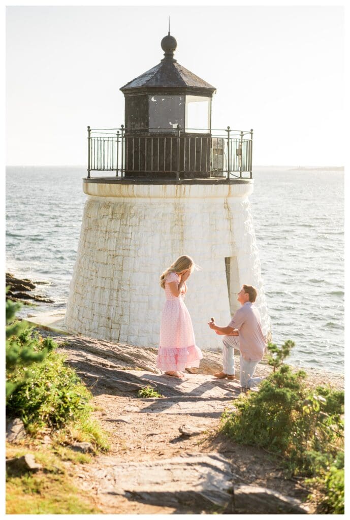 Woman reacts to a surprise proposal at the base of Castle Hill Inn Lighthouse in Newport, Rhode Island.